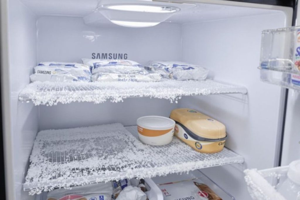 Ice-covered shelves inside a Samsung refrigerator, showcasing freezing temperatures affecting food in Spokane.