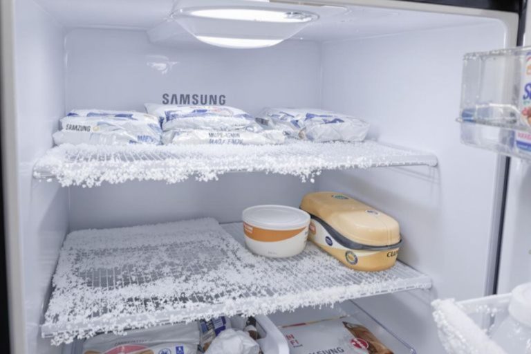 Ice-covered shelves inside a Samsung refrigerator, showcasing freezing temperatures affecting food in Spokane.